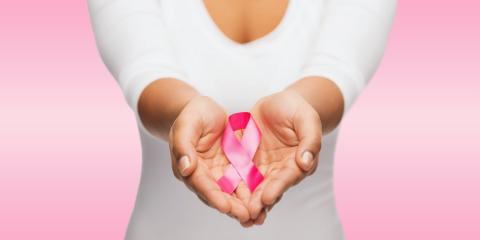 Woman holds breast cancer ribbon
