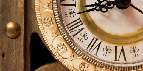Improve Your Life with the Science of Timing Old wooden clock showing time, close-up.
