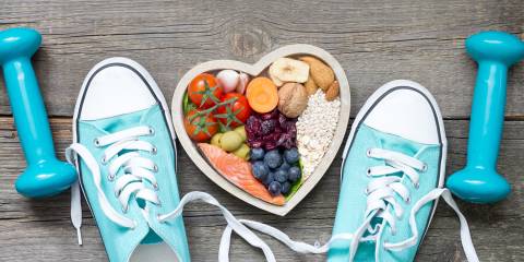 fitness equipment and running shoes next to a bowl of heart-healthy food