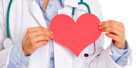 Holistic Heart Health a doctor holding a paper cut-out of a heart