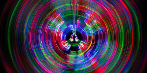 soundwaves of different color emanating from the dark