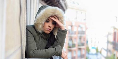 A sad woman bundled up for the weather