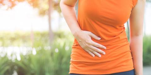 a woman breathing through pain in her abdomen