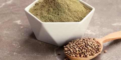 a spoon full of hemp seeds, and a bowl of protein powder