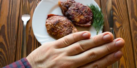a man refusing a delicious steak