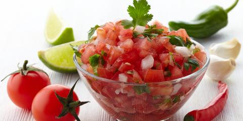Bowl of salsa surrounded by the ingredients. 