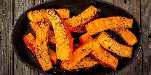 Roasted Pumpkin Wedges a bowl of seasoned pumpkin wedges