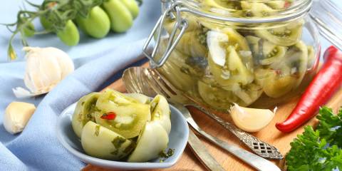 a jar of pickled green tomatoes
