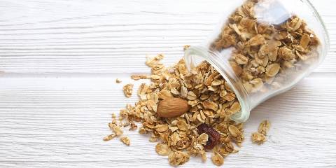 Chocolate-Cherry Granola with Almonds a jar of granola and nuts