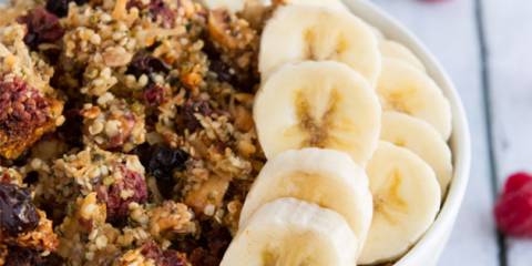 a bowl of granola made from nuts, seeds, and berries