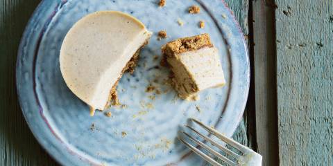 A plated mini-cheesecake with a little taste cut out