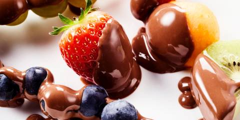 Chocolate-Honey-Almond Fondue melty chocolate all over fresh strawberries, blueberries, kiwis, and mango