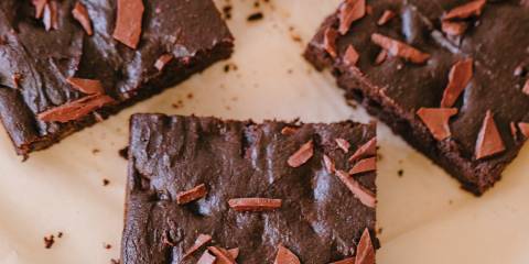 Double Chocolate Brownies freshly baked brownies cut into squares on parchment paper.