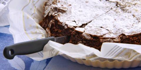 a deep dark chocolate cake with confectioner's sugar on top