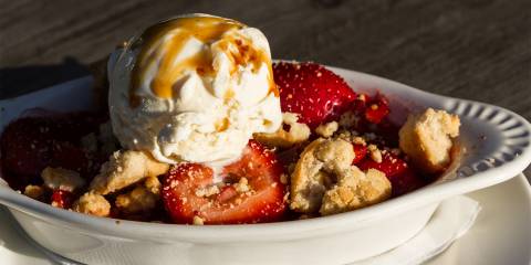 Gluten-Free Strawberry-Rhubarb Crisp a dish of strawberry-rhubarb crisp topped with ice cream
