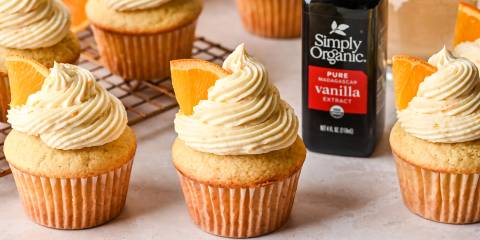 a batch of mimosa cupcakes and a bottle of vanilla extract
