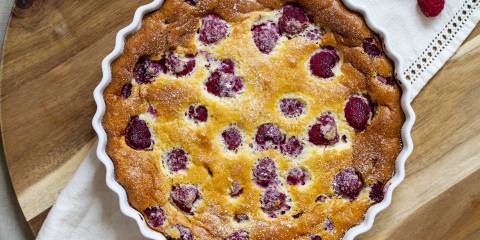 a freshly-baked raspberry clafoutis in a pan