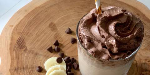 Super Bananutella Smoothie A Bananutella Smoothie on a wooden cutting board ready to enjoy.