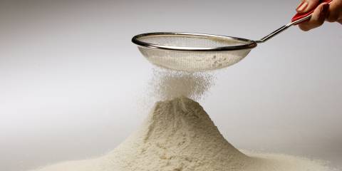 DIY Gluten-Free Flour Mix alternative flour falling from a sifter into a pile