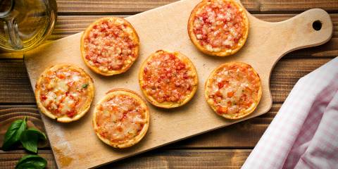 Butternut Squash and Red Onion Mini Pizzas mini pizzas on a cutting board