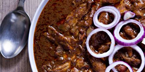 Chicken Mole A plate of chicken in brown mole sauce