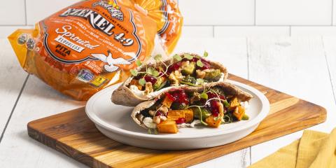 pita bread stuffed with cranberries and vegetables on cutting board