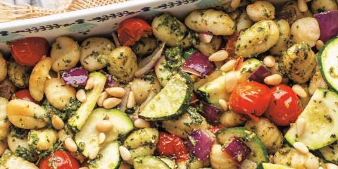 gnocchi and veggies with pesto in a pan