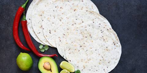 corn tortillas, sliced avocado, and chili peppers