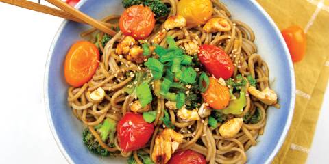 Soba with Veggies, Maple Cashews & Miso Sauce a bowl of noodles with cherry tomatoes and candied cashews
