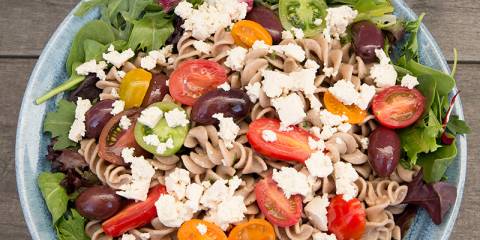Spiral Pasta Salad with Tofu Feta A bowl of pasta salad topped with vegan tofu feta