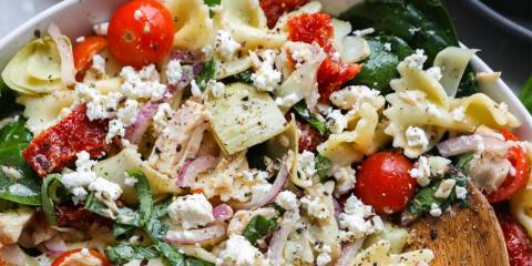 a bowl of pasta salad with veggies and tuna fish