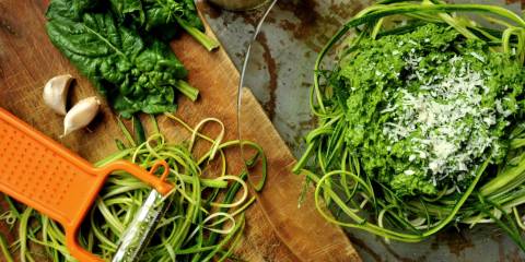 zucchini being shredded into noodles