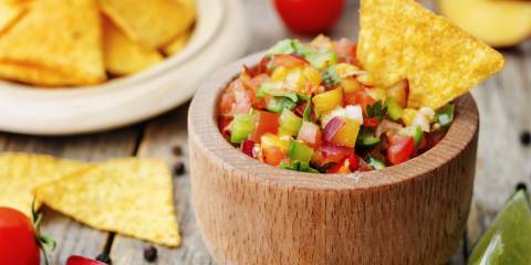 Fresh Peach Salsa A tortilla chip dipped into fresh peach salsa
