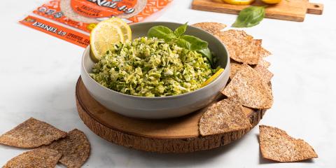 Green Confetti Salad a bowl of green vegetable dip with some tortilla chips