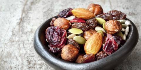 Trail mix in a small black bowl. 