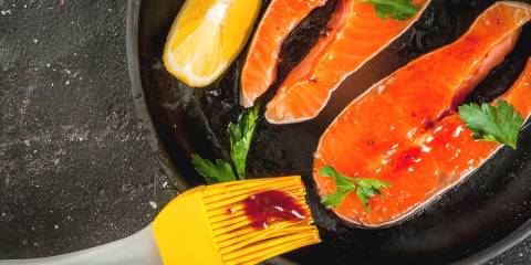 3 Sauces for Grilled Salmon salmon being slathered with sauce for the grill