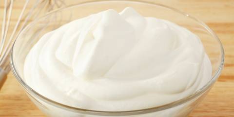 a dish of whipped cream and a whisk