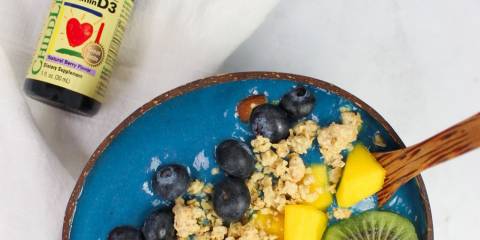 Tropical Blue Smoothie Bowl a plate of fruit and a vial of vitamins