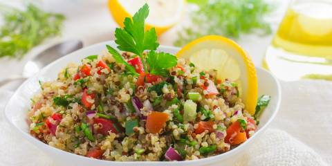 a bowl of buckwheat, diced tomatoes, onions, and spices