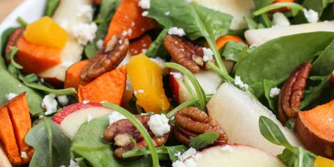 Fruity Harvest Salad a salad with sweet potatoes, spinach, and nuts