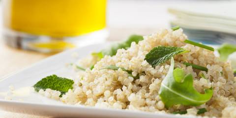 Quinoa Salad Quinoa with green leaves in a white dish