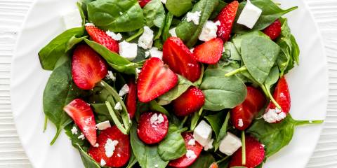Spinach and Strawberry Salad a plate of spinach, crumbled feta, and sliced strawberries