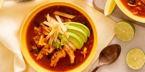 Chipotle Chicken Tortilla Soup a bowl of spicy red chicken soup with avocado