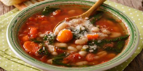 Hearty Bean and Potato Soup a bowl of tomato-based soup with beans and spinach