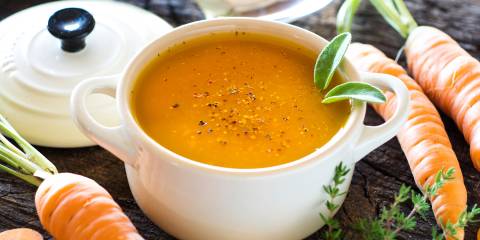 a bowl of fresh raw carrot soup
