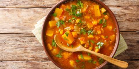 Traditional thick sweet potato soup with lentils close up in a bowl on the table.