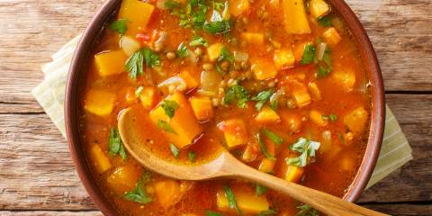 Sweet Potato Stew with Lentils and Spinach a bowl of stew with sweet potato, lentils, and leafy greens