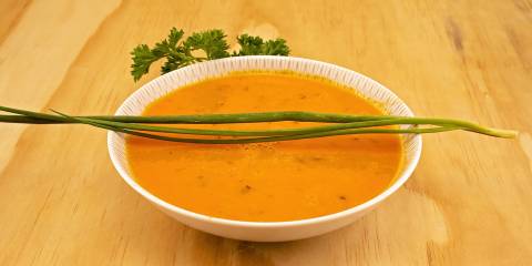 Tomato Soup with Fresh Chives a bowl of tomato soup with fresh chives