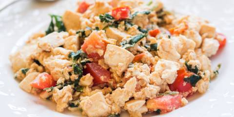 Italian Tofu Scramble a plate of scrambled tofu with greens and tomatoes