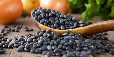 Black beans on a wooden spoon